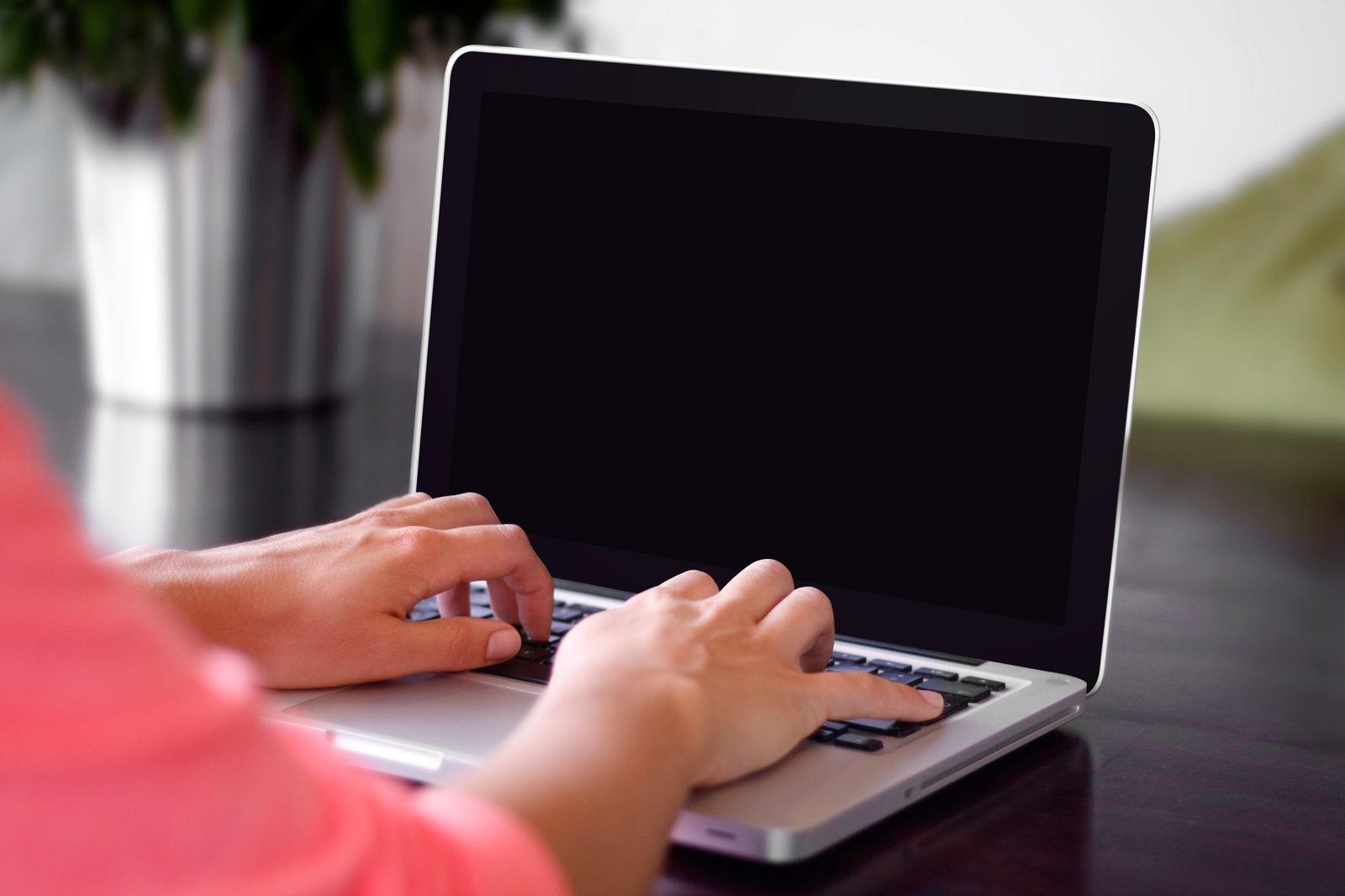 Close-up of hands typing on a laptop keyboard, suggesting concurrent cognitive work.