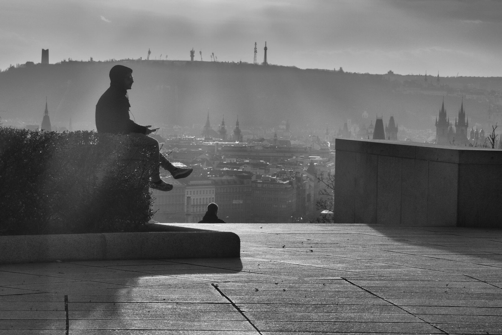 A solitary person waiting on a high terrace above Prague